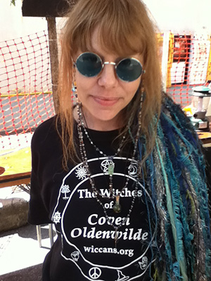Lady Passion wearing her new terrarium talisman atop her Witches of Coven Oldenwilde T-shirt.