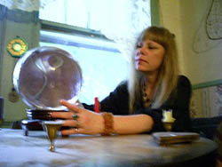 Clairvoyant psychic reader, divination specialist Lady Passion using a crystal ball to give a psychic clairvoyant reading and divination