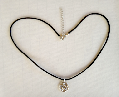Silver pentagram on black cord with silver attachment and chain